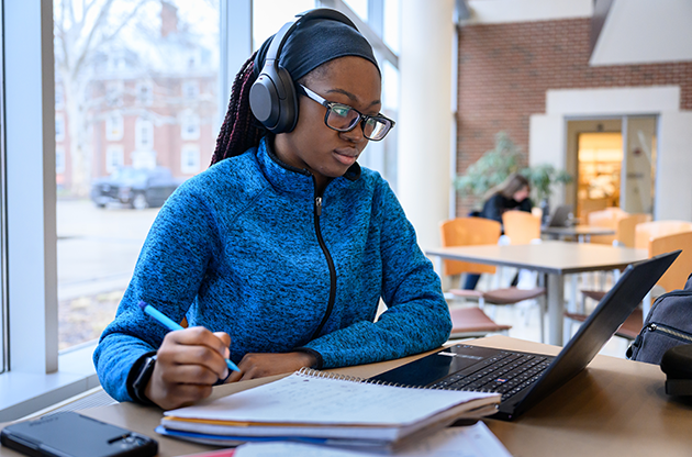 University student at a laptop in the library